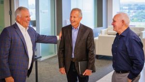 Left to right: Lochinvar’s Jeff Drummonds, Bill Vallett, Jr. (center), and LBMC’s Mike Cain in conversation, reflecting the enduring personal-professional bond between the companies.